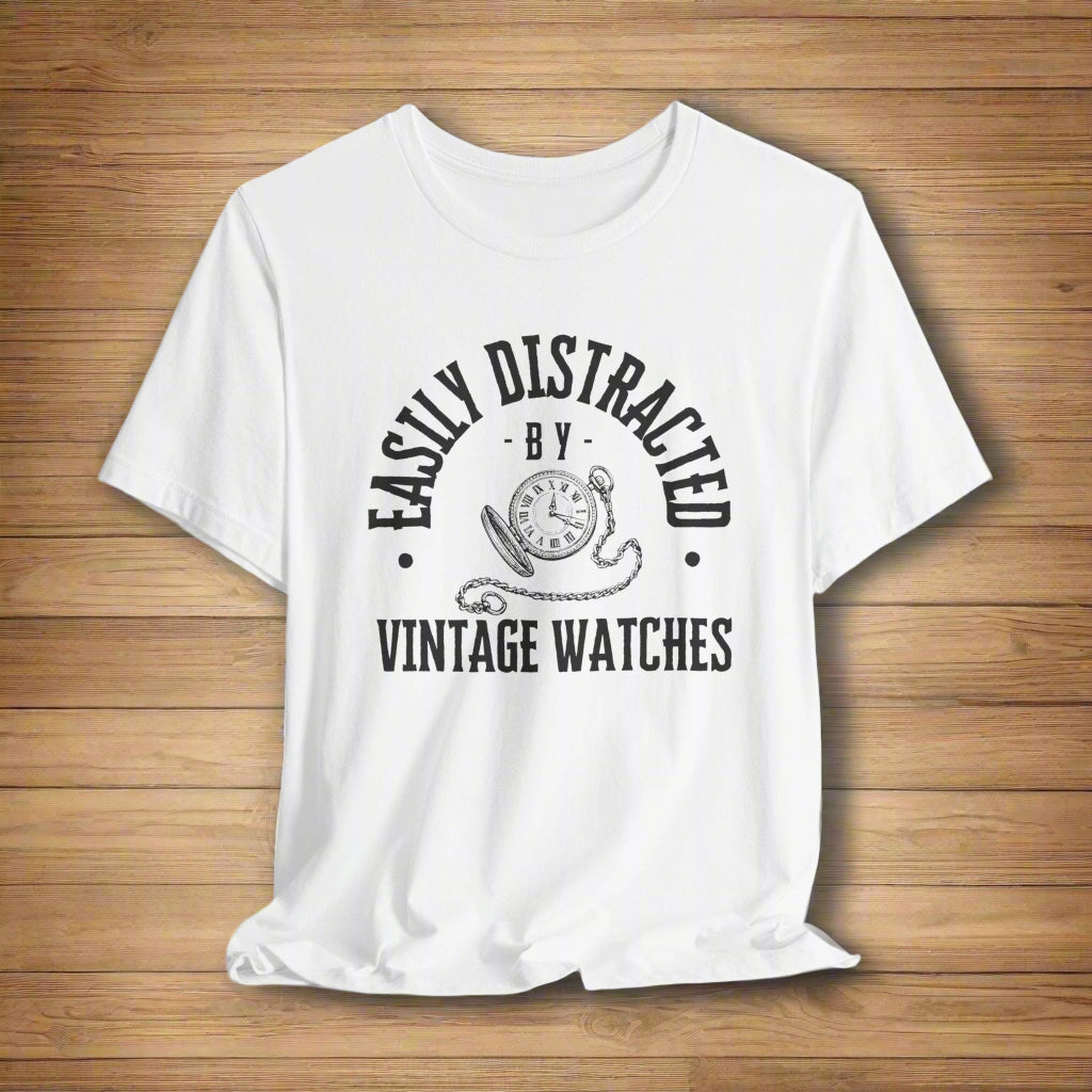White t-shirt with black text and graphic on a light gray background