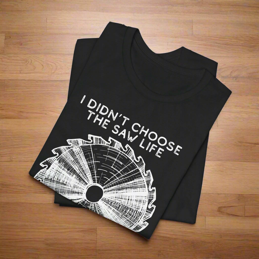 Black t-shirt with white graphic and text 'I Didn't Choose the Saw Life' on a white background