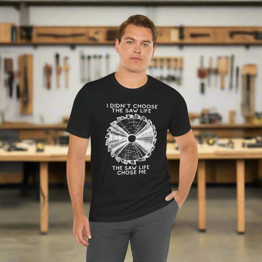 Man wearing a black t-shirt with a sawmill graphic and text on a white background
