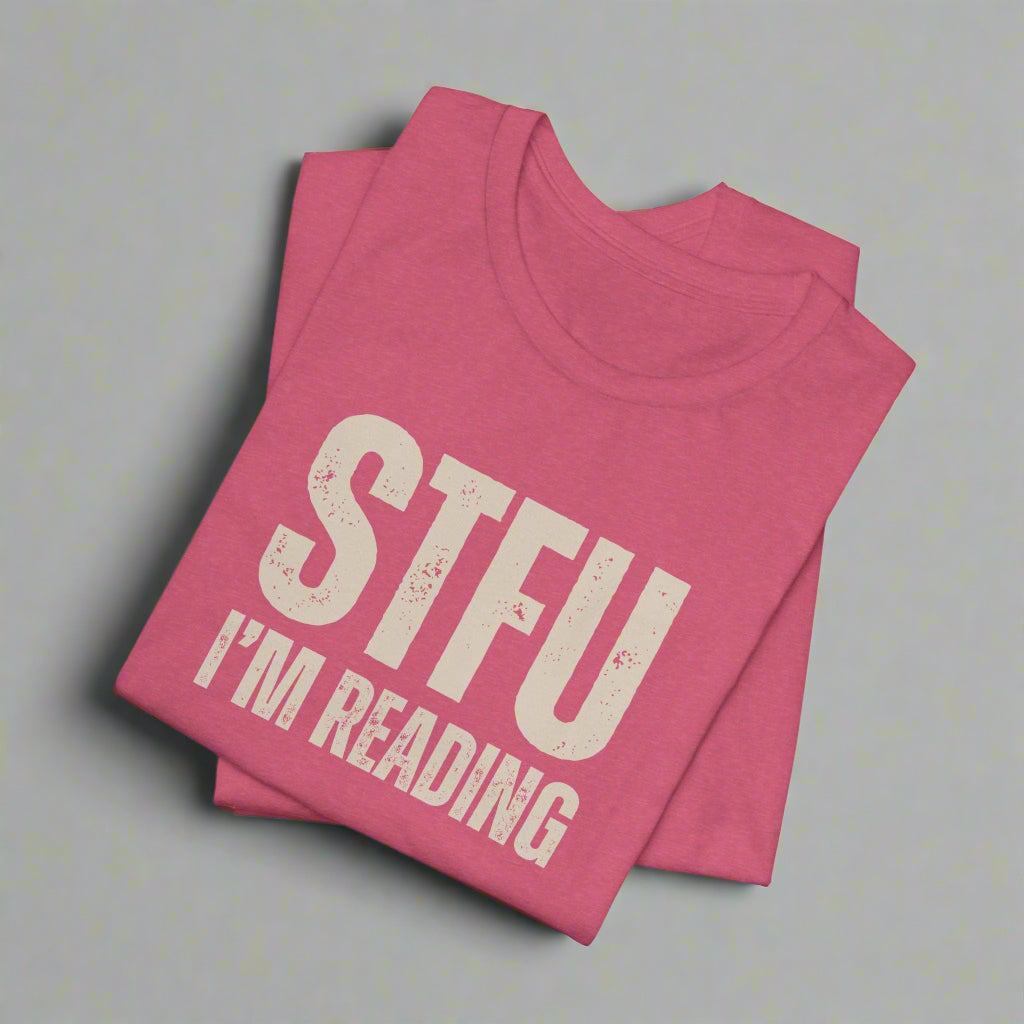 Pink t-shirt with 'STFU I'm Reading' text on a white background