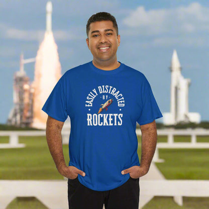 Man wearing a blue t-shirt with 'Easily Distracted by Rockets' text and graphic on a white background