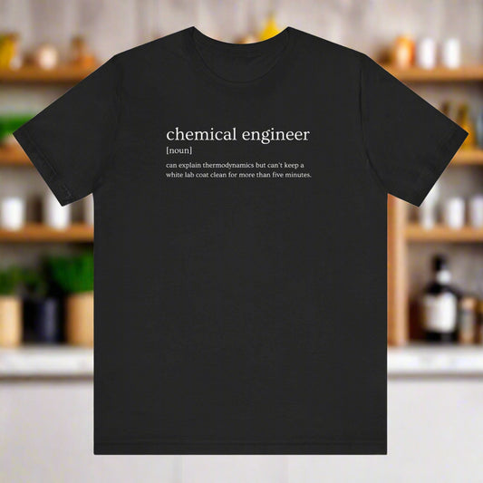 Black t-shirt with a humorous definition of a chemical engineer on a blurred kitchen background