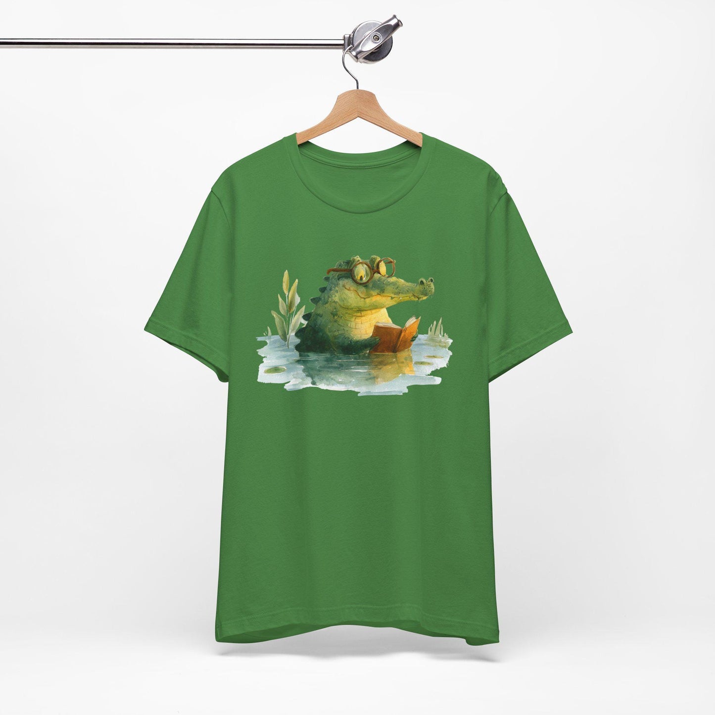 Green t-shirt with a crocodile graphic on a hanger against a white background