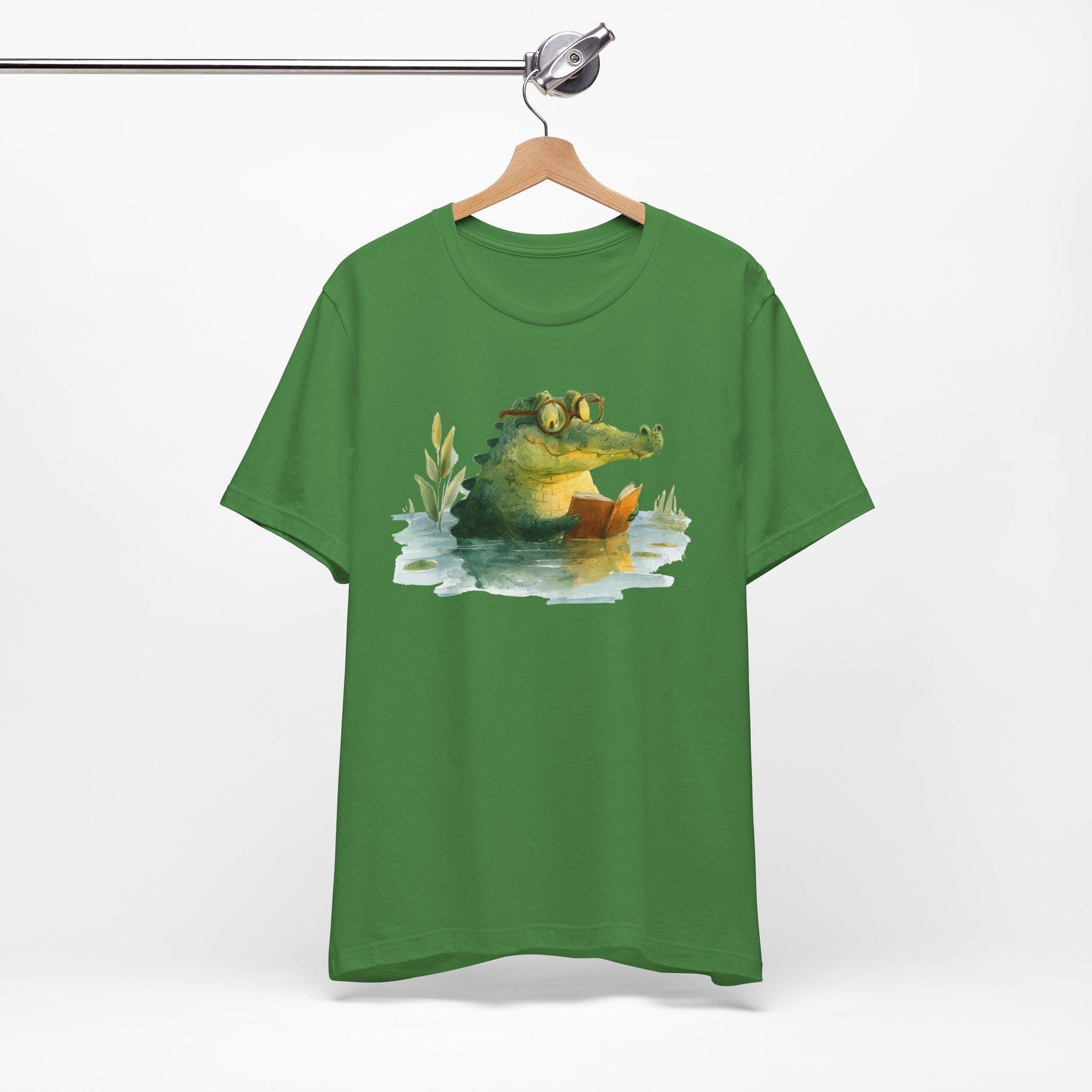 Green t-shirt with a crocodile graphic on a hanger against a white background