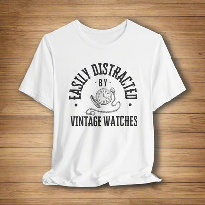 White t-shirt with black text and graphic on a light gray background
