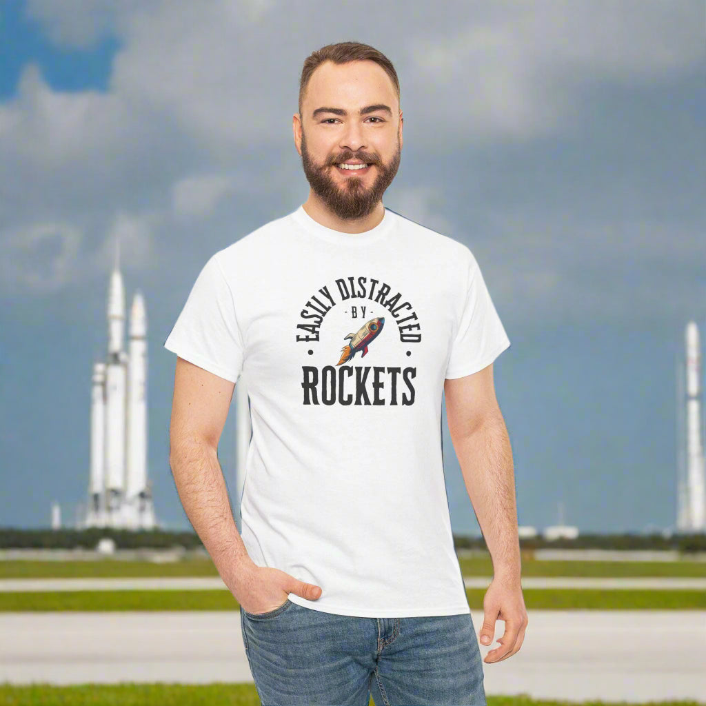 Man wearing a white t-shirt with 'Easily Distracted by Rockets' text and graphic on a white background