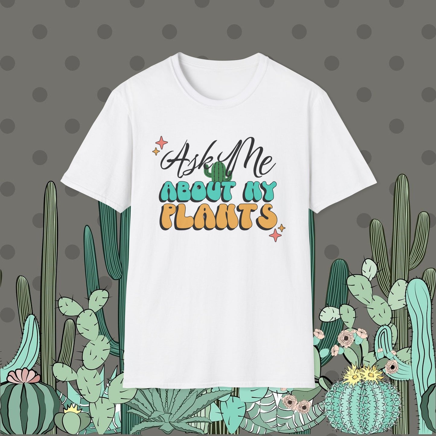 White t-shirt with 'Ask Me About My Plants' text on a polka dot background with cacti illustrations.