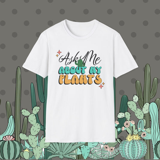 White t-shirt with 'Ask Me About My Plants' text on a polka dot background with cacti illustrations.