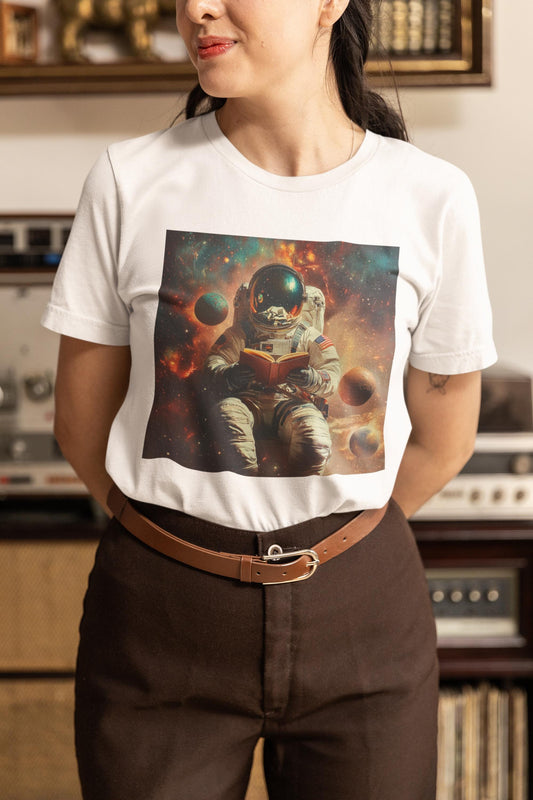 Person wearing a white t-shirt with an astronaut graphic in a room with vintage equipment.