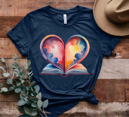 Navy blue t-shirt with a colorful heart design on a wooden surface with a hat and plant.