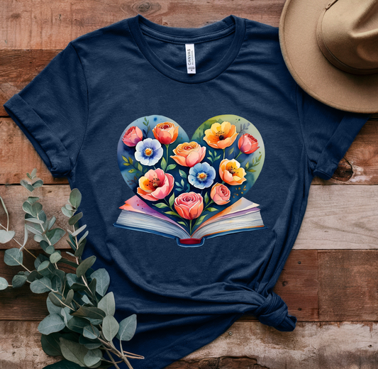 Navy blue t-shirt with a colorful heart-shaped floral design on a wooden surface.