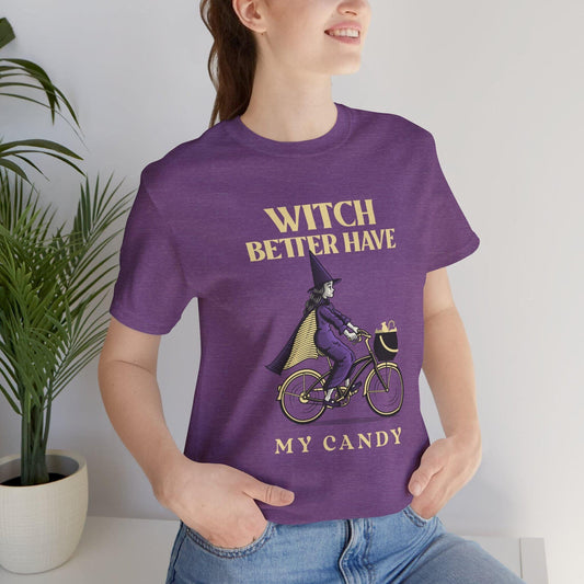 Person wearing a purple t-shirt with a graphic design and text, standing indoors.