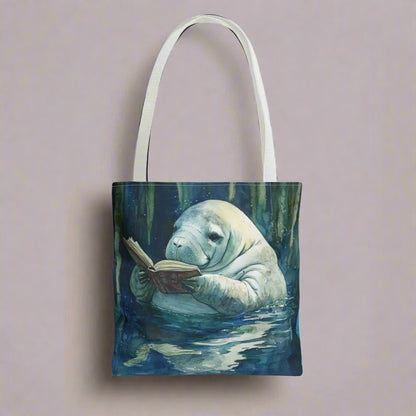 Tote bag with a manatee reading a book design on a white background