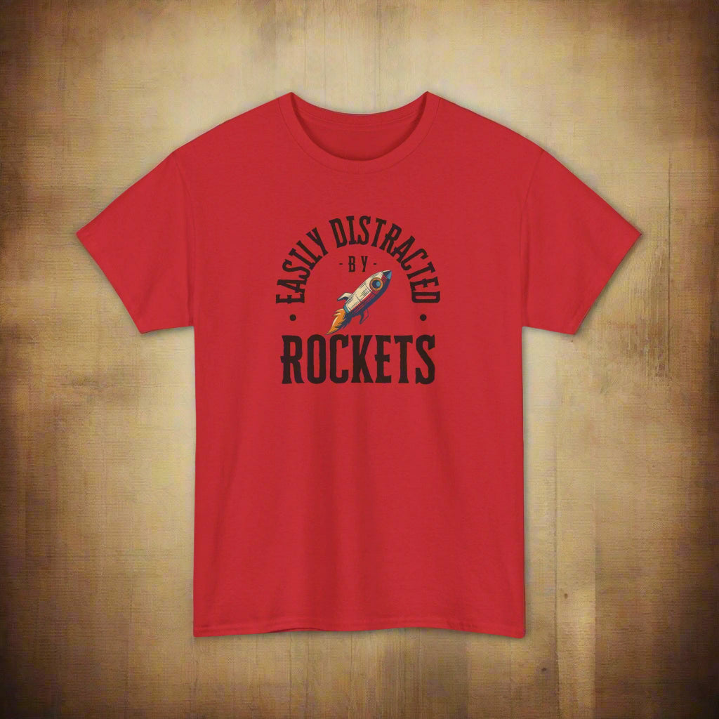Red t-shirt with 'Easily Distracted by Rockets' graphic on a white background