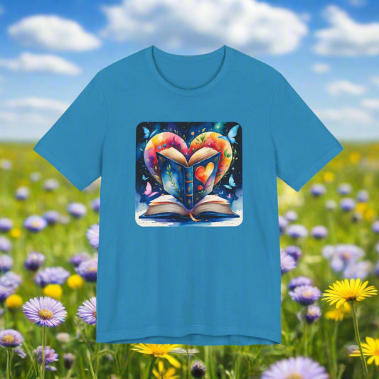 Blue t-shirt with a colorful graphic of an open book shaped like a heart on a white background