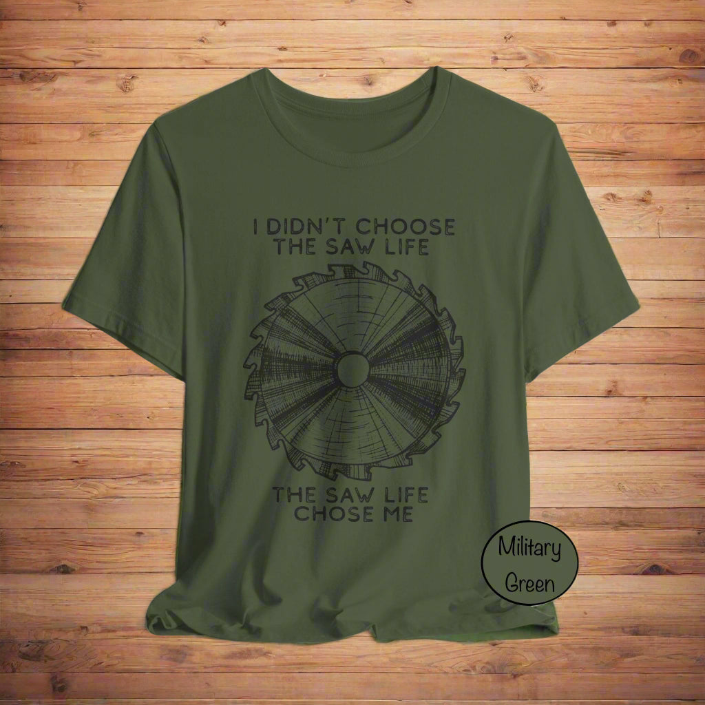 Military green t-shirt with saw graphic and text on a light gray background