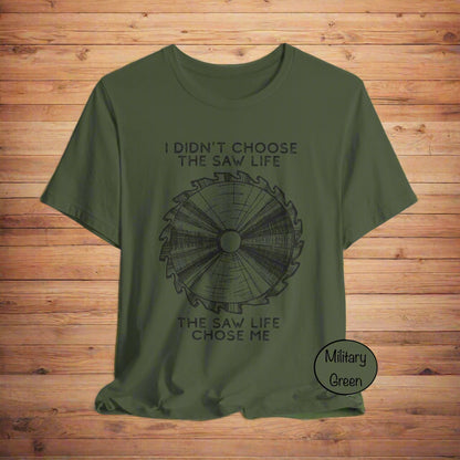 Military green t-shirt with saw graphic and text on a light gray background