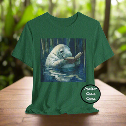 Green t-shirt with a manatee reading a book graphic on a white background