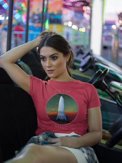 Woman wearing a red t-shirt with a graphic design, sitting in an amusement park.