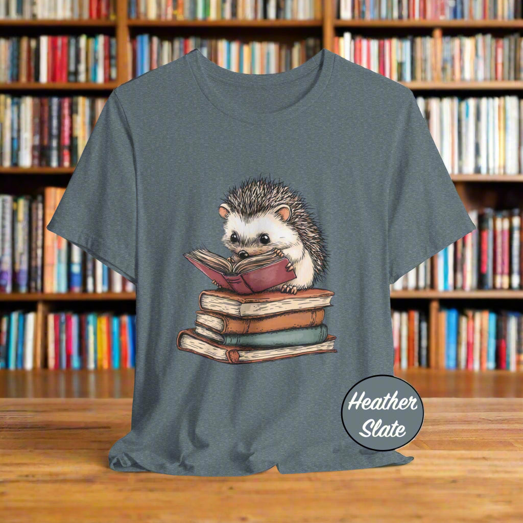 Heather slate t-shirt with a hedgehog reading a book graphic on a light gray background