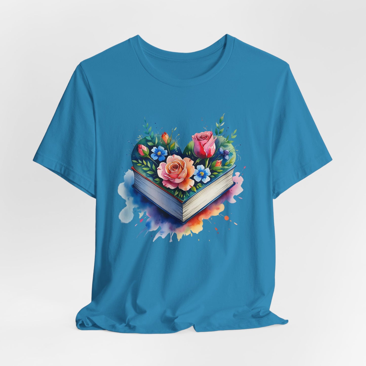 Blue t-shirt with a heart-shaped book and floral design on a light gray background