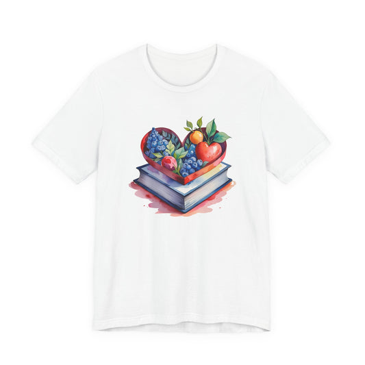 White t-shirt with a colorful design of a heart made of fruits and books on a white background
