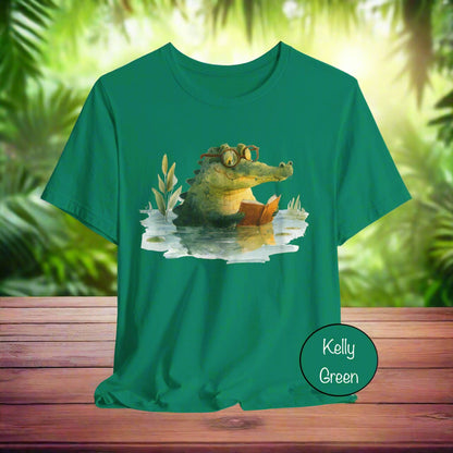 Green t-shirt with a crocodile reading a book graphic on a light gray background