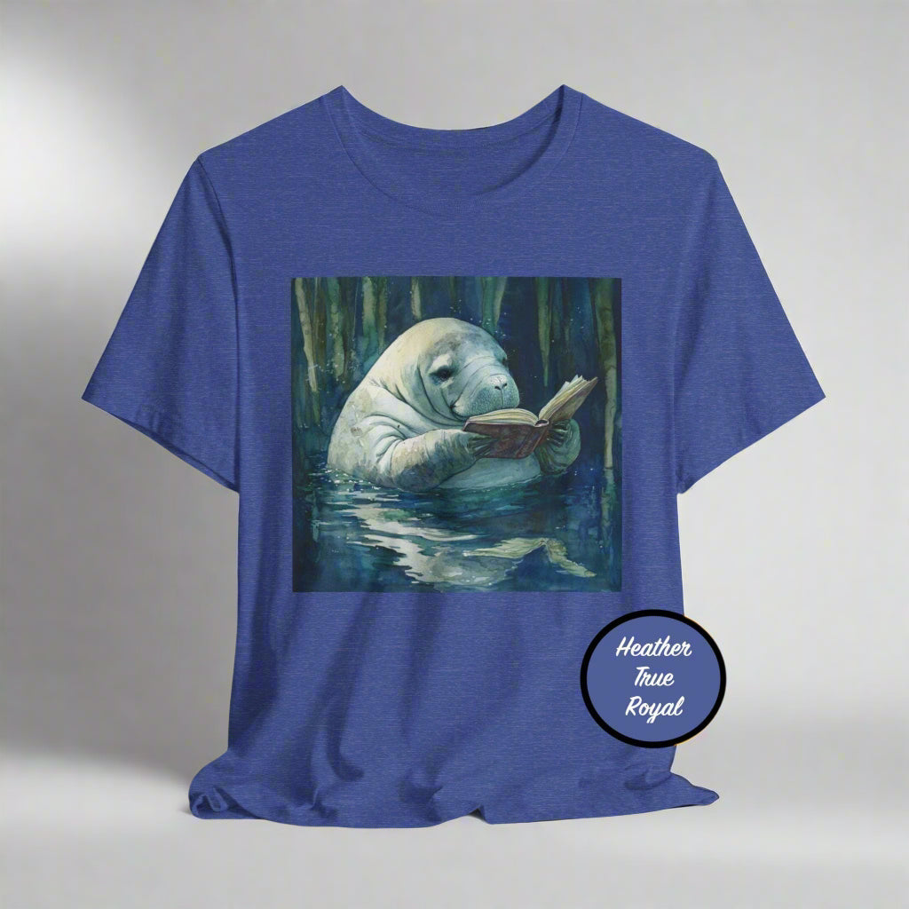 Blue t-shirt with a manatee reading a book graphic on a white background