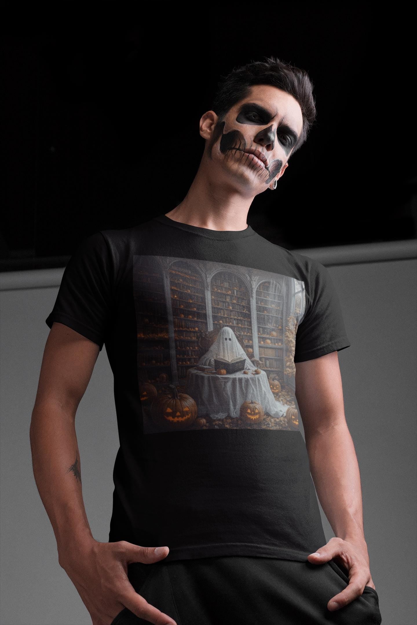 Person wearing a black t-shirt with a Halloween-themed design, posing against a dark background.