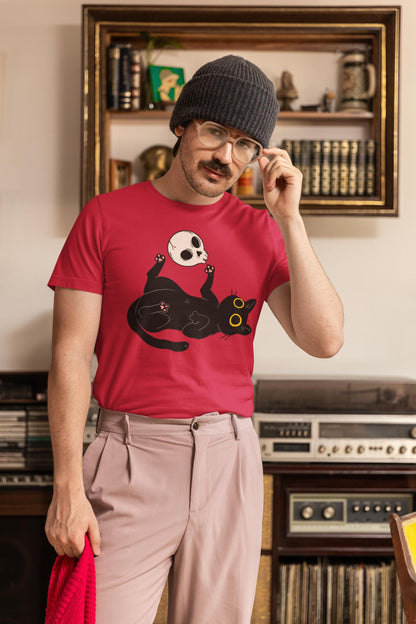 Man wearing a red t-shirt with a black cat design, standing in a room with vintage stereo equipment.