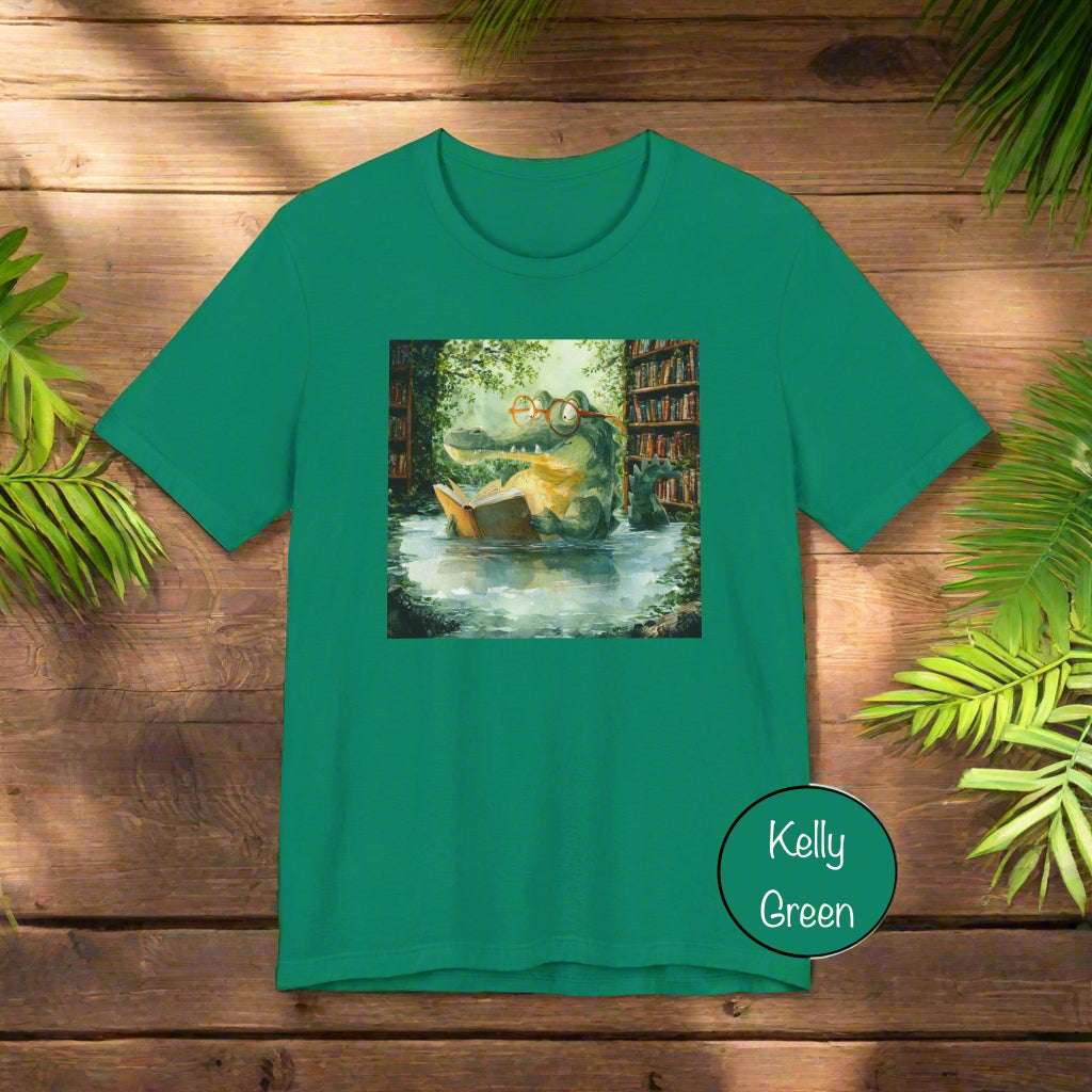 Green t-shirt with a printed design of a boat on water and trees, on a white background.