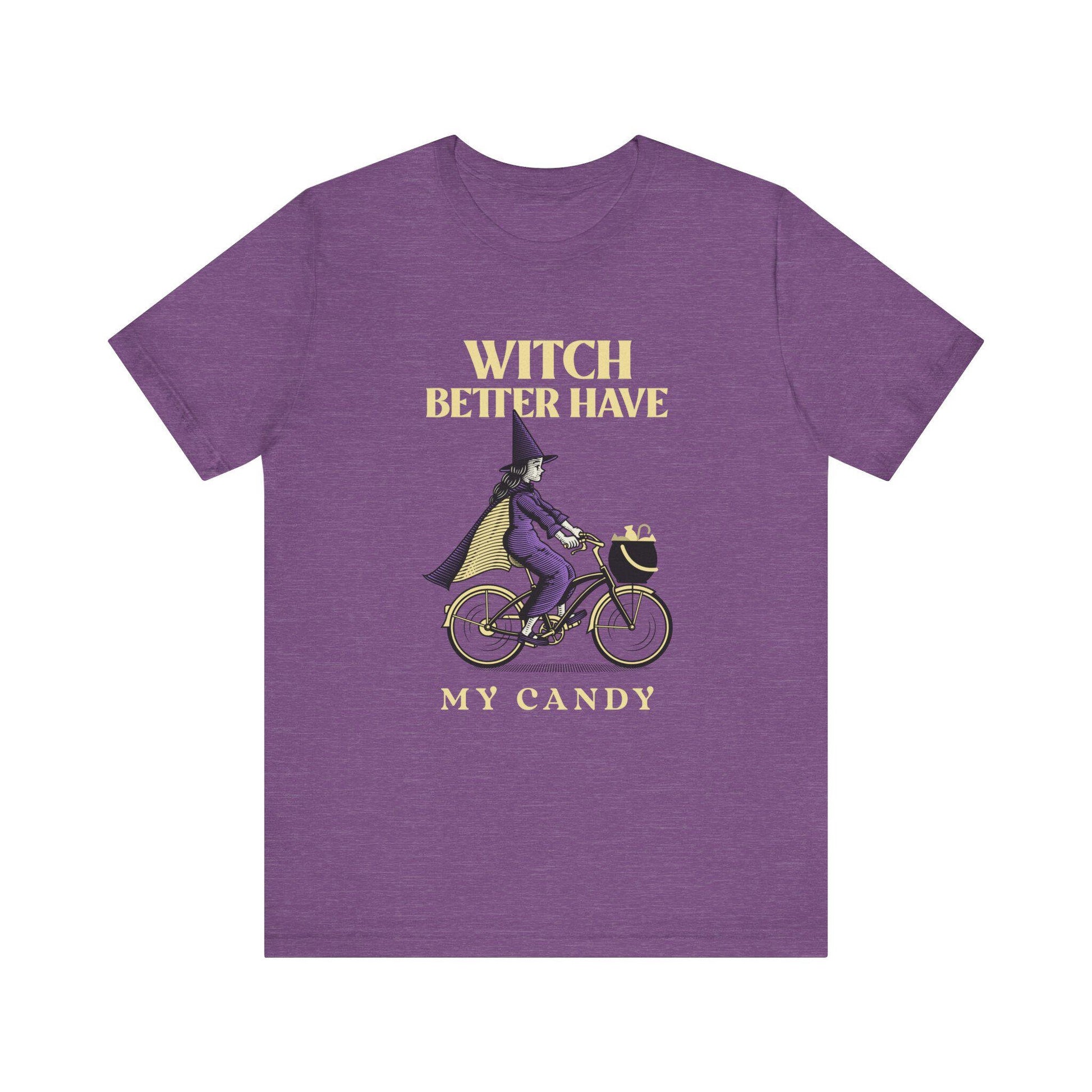 Purple t-shirt with a witch riding a bike graphic and text on a white background