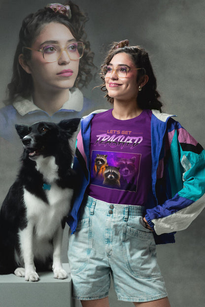 Woman in a purple graphic t-shirt and denim shorts standing next to a black and white dog, with a gray background.