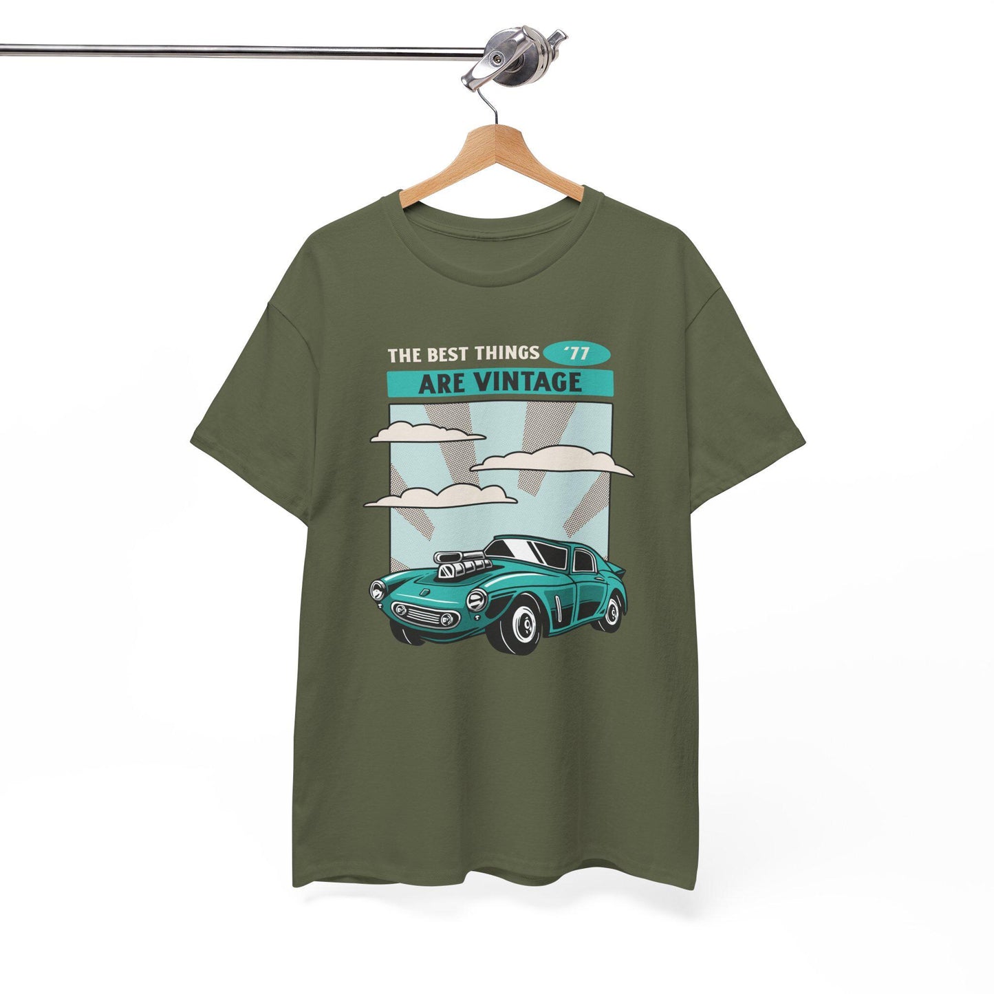Green t-shirt with vintage car graphic and text on a hanger against a white background