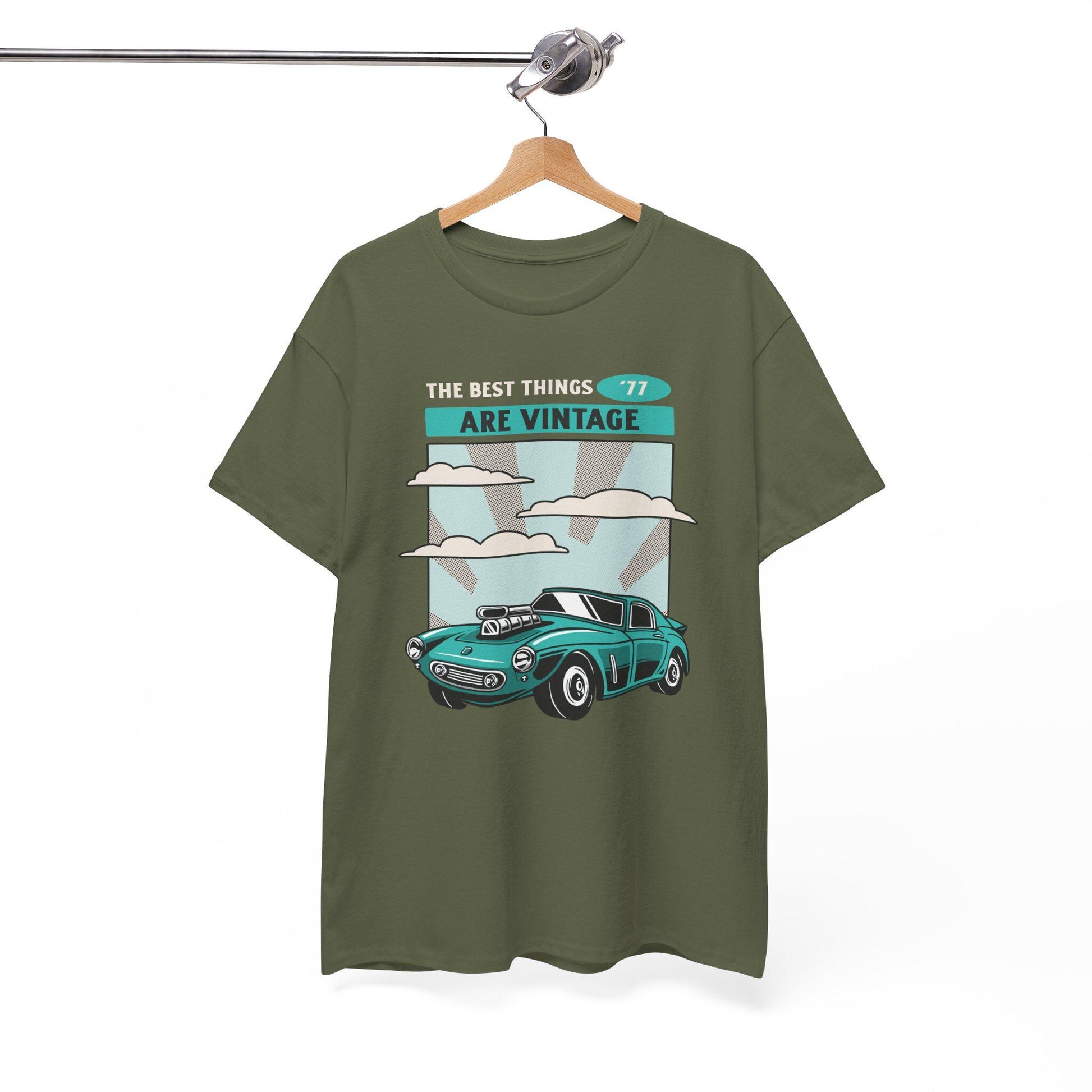 Green t-shirt with vintage car graphic and text on a hanger against a white background