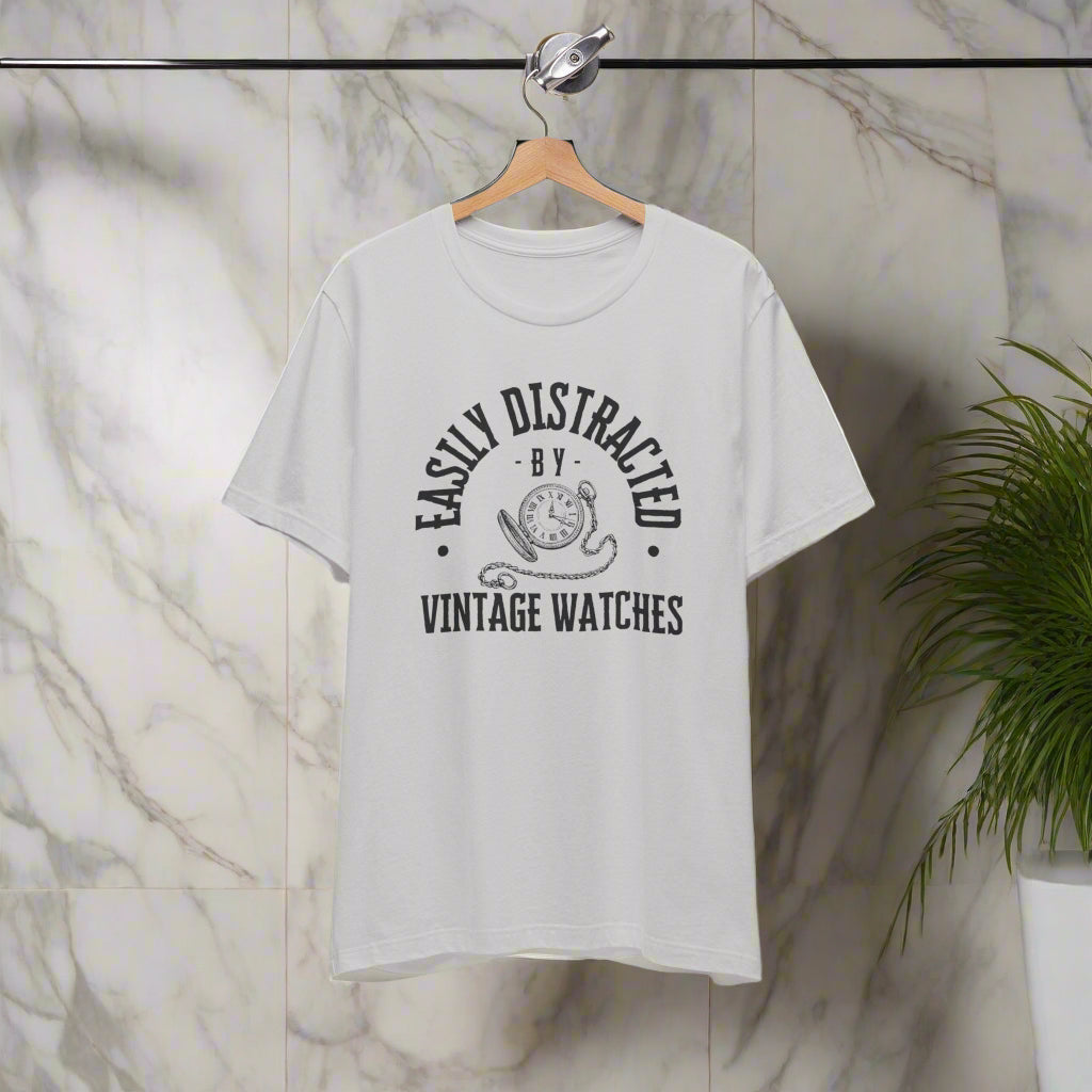 Gray t-shirt with black text and graphic on a hanger against a white background