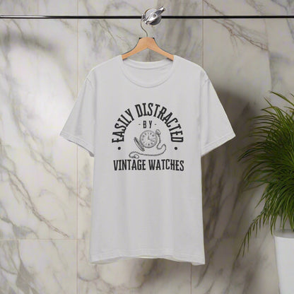 Gray t-shirt with black text and graphic on a hanger against a white background