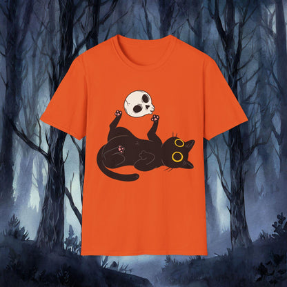 Orange t-shirt with a black cat and skull design against a dark forest background