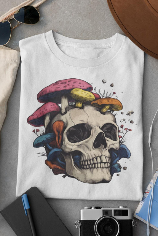 White t-shirt with colorful skull design on a gray surface with accessories.