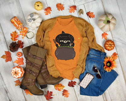 Fall-themed outfit with sweater, jeans, boots, and accessories on a wooden floor with pumpkins and leaves.
