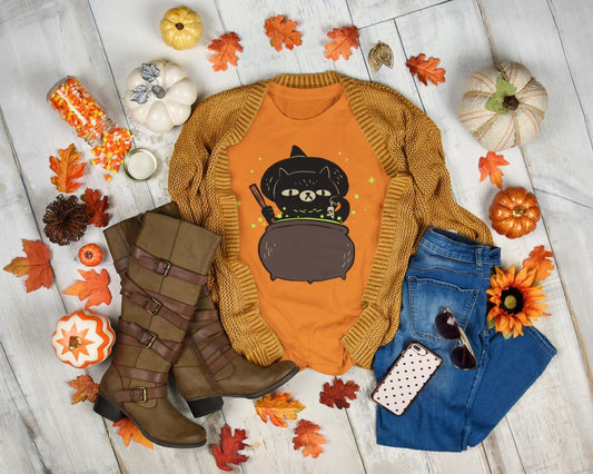 Fall-themed outfit with sweater, jeans, boots, and accessories on a wooden floor with pumpkins and leaves.